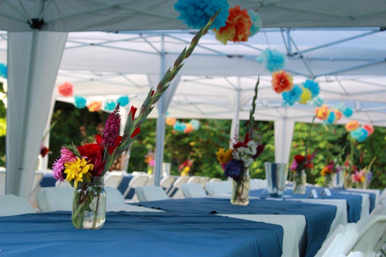 Tables with blue cloths and handpicked flower centrepieces ready for wedidng brunch