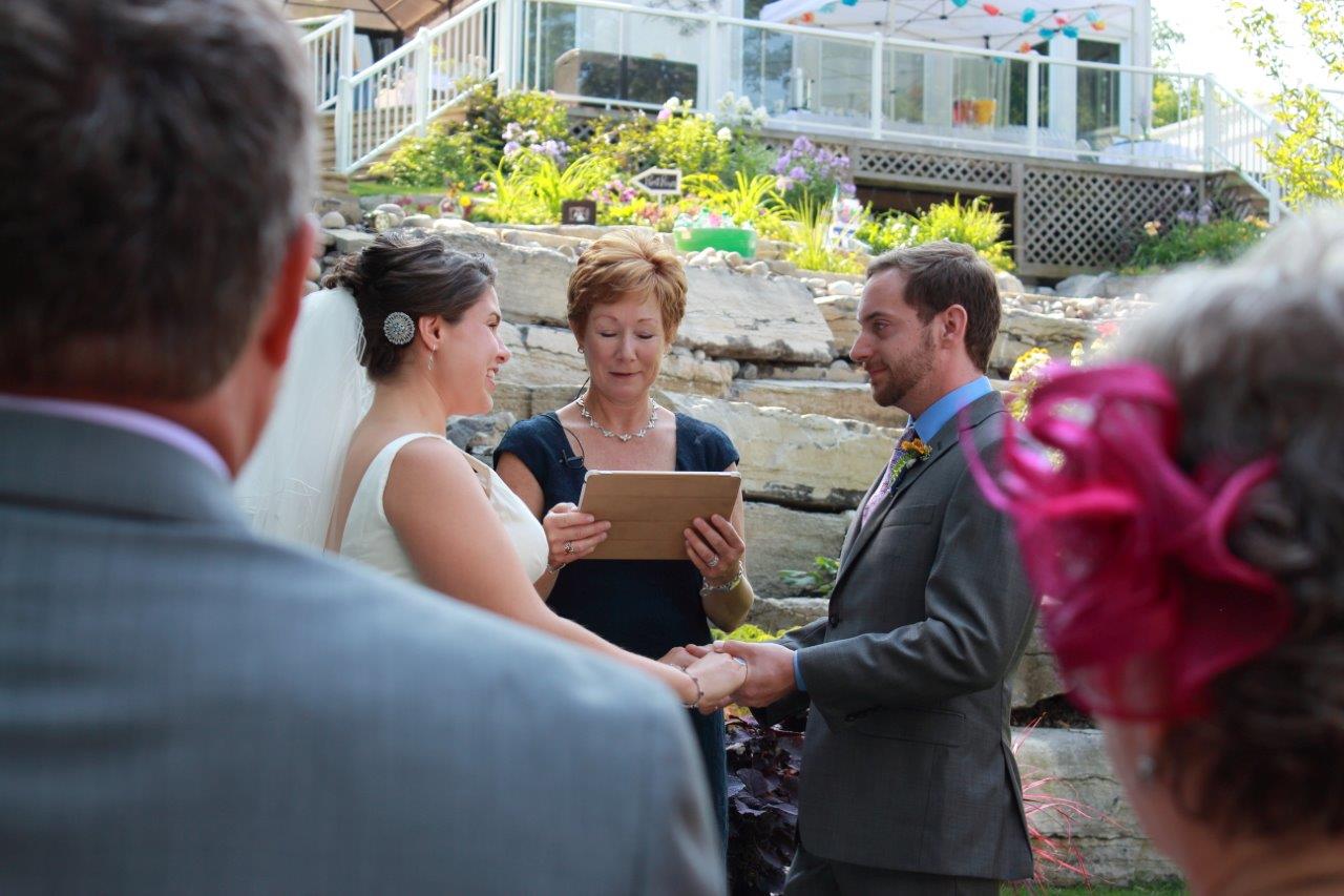 A couple looking at each other as the officiant conducts their wedding ceremony