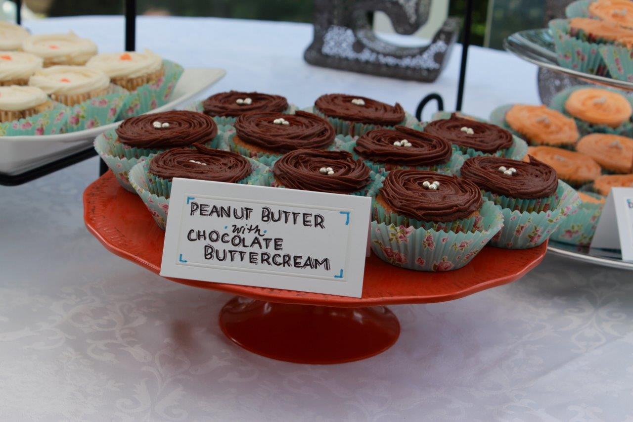 Homemade peanut butter with chocolate buttercream cupcakes on a red cake stand