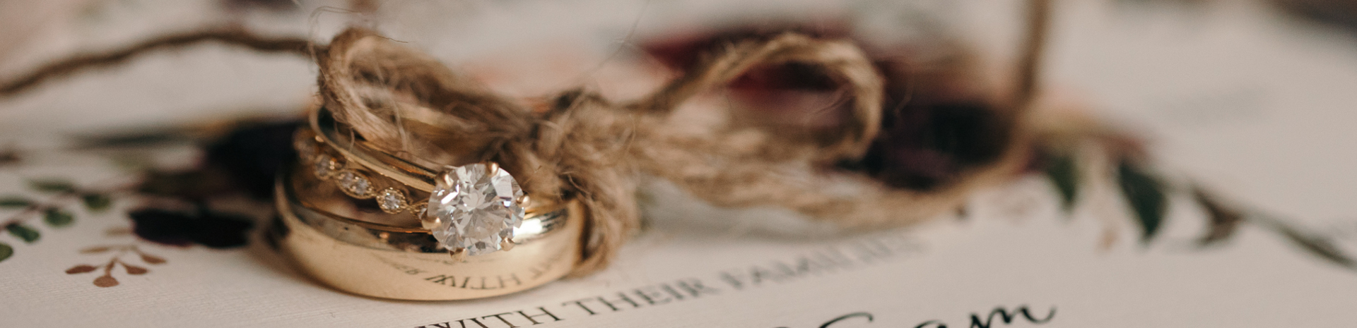 Two rings tied together with string lying on top of the order of service